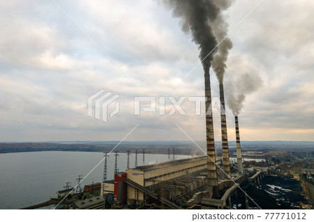Aerial view of coal power plant high pipes with black smoke moving up polluting atmosphere. Aerial view of coal power plant high pipes with black smoke moving up polluting atmosphere. 77771012