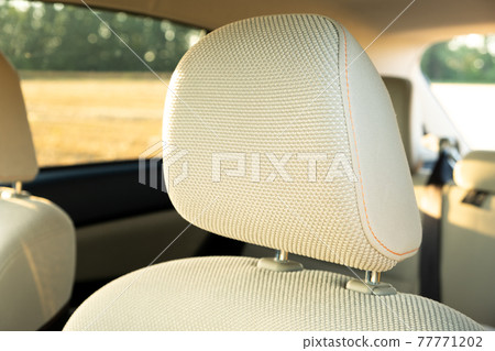 Closeup detail of light beige car headrests. Closeup detail of light beige car headrests. 77771202