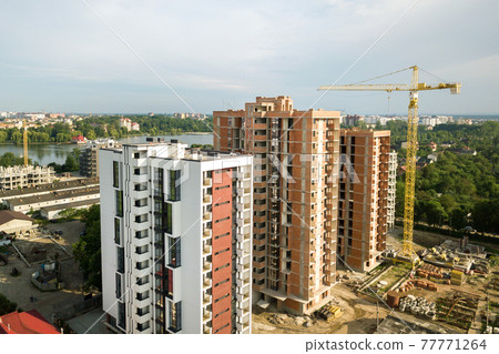 Aerial view of tall residential apartment buildings under construction. Real estate development. 77771264