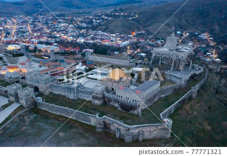 Aerial view of fortified Rabati Castle of Akhaltsikhe on evening 77771321