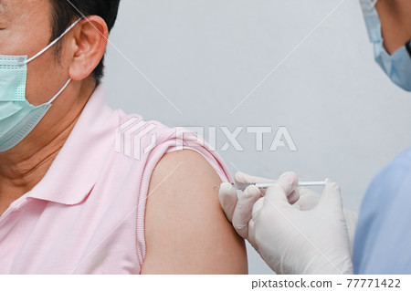 Doctor giving COVID-19 Vaccine shot to patient for can help stop pandemic, COVID-19 vaccines can help reduce the transmission of the new coronavirus from person to person Doctor giving COVID-19 Vaccine shot to patient for can help stop pandemic, COVID-19 vaccines can help reduce the transmission of the new coronavirus from person to person 77771422