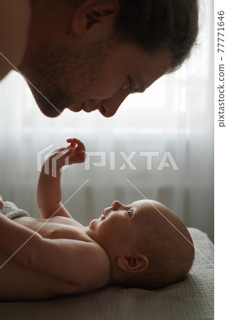 Crop father looking at cute baby at home Crop father looking at cute baby at home 77771646
