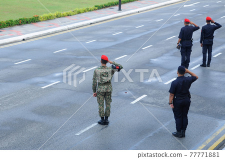 SEREMBAN, MALAYSIA -AUGUST 31, 2016: Malaysian police on duty in full uniform. The police were in control of the public during the celebration of Independence Day of Malaysia. SEREMBAN, MALAYSIA -AUGUST 31, 2016: Malaysian police on duty in full uniform. The police were in control of the public during the celebration of Independence Day of Malaysia. 77771881