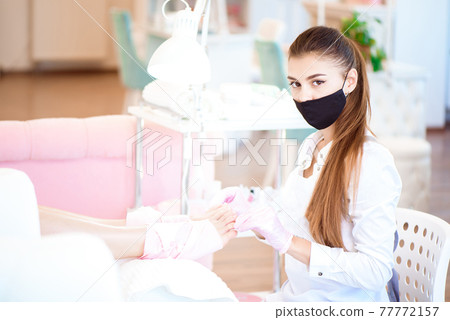 Pedicure in beauty salon. Nail polishing with nail polish. Close up. Pedicure in beauty salon. Nail polishing with nail polish. Close up. 77772157