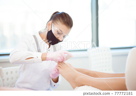 Woman feet receiving pedicure in a Day Spa 77772181