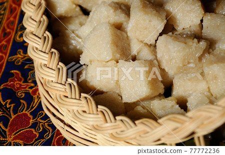Glutinous rice or locally called pulut impit cook and steam and the press in a container. It was then cut into cubes before serving. Malay traditional food. 77772236
