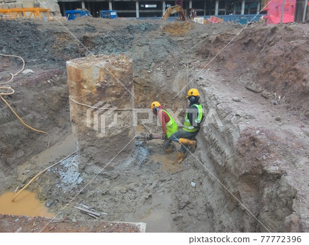 KUALA LUMPUR , MALAYSIA -MARCH 23, 2017: Building foundation work by construction workers at the construction site. Piling works and piles cap fabricating works. KUALA LUMPUR , MALAYSIA -MARCH 23, 2017: Building foundation work by construction workers at the construction site. Piling works and piles cap fabricating works. 77772396
