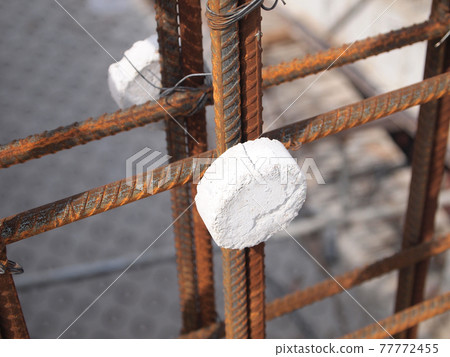 JOHOR, MALAYSIA -MARCH 18, 2017: Steel reinforcement bar at the construction site. It uses to strengthen concrete to form reinforced concrete. It is tied together by workers using tiny wire. JOHOR, MALAYSIA -MARCH 18, 2017: Steel reinforcement bar at the construction site. It uses to strengthen concrete to form reinforced concrete. It is tied together by workers using tiny wire. 77772455