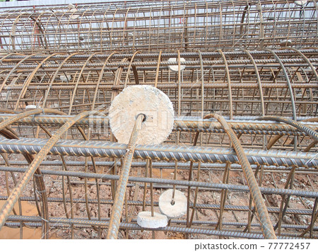 JOHOR, MALAYSIA -MARCH 18, 2017: Steel reinforcement bar at the construction site. It uses to strengthen concrete to form reinforced concrete. It is tied together by workers using tiny wire. JOHOR, MALAYSIA -MARCH 18, 2017: Steel reinforcement bar at the construction site. It uses to strengthen concrete to form reinforced concrete. It is tied together by workers using tiny wire. 77772457