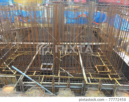 JOHOR, MALAYSIA -MARCH 18, 2017: Steel reinforcement bar at the construction site. It uses to strengthen concrete to form reinforced concrete. It is tied together by workers using tiny wire. JOHOR, MALAYSIA -MARCH 18, 2017: Steel reinforcement bar at the construction site. It uses to strengthen concrete to form reinforced concrete. It is tied together by workers using tiny wire. 77772458
