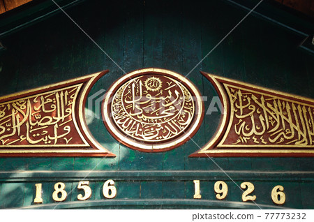 JOGJAKARTA, INDONESIA -JUNE 12, 2014: Wood carving detail with floral & arabic word at old Mosque of Masjid Besar Mataram Kotagede. Build on 1575. JOGJAKARTA, INDONESIA -JUNE 12, 2014: Wood carving detail with floral & arabic word at old Mosque of Masjid Besar Mataram Kotagede. Build on 1575. 77773232