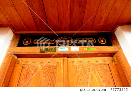 JOGJAKARTA, INDONESIA -JUNE 12, 2014: Wood carving detail with floral & arabic word at old Mosque of Masjid Besar Mataram Kotagede. Build on 1575. JOGJAKARTA, INDONESIA -JUNE 12, 2014: Wood carving detail with floral & arabic word at old Mosque of Masjid Besar Mataram Kotagede. Build on 1575. 77773235