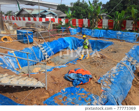 JOHOR, MALAYSIA -MARCH 29, 2016: Construction workers spraying the anti termite chemical treatment to the soil at the construction site.  77773369