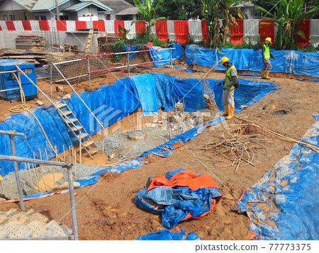 JOHOR, MALAYSIA -MARCH 29, 2016: Construction workers spraying the anti termite chemical treatment to the soil at the construction site.  77773375