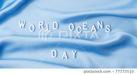 World oceans day in white letters on blue wave textile, june 8 holiday 77773510
