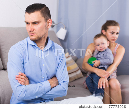 Sad male and female with child thinking about quarrel Sad male and female with child thinking about quarrel 77773928