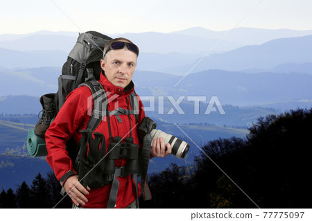 the equipped with the traveler photographer in the red jacket 77775097