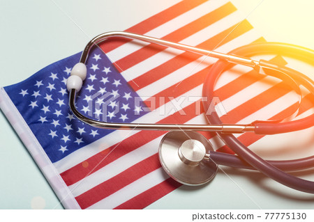 USA medicine background. Stethoscope on the American flag. Healthcare and medical services in the USA concept. USA medicine background. Stethoscope on the American flag. Healthcare and medical services in the USA concept. 77775130