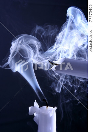 two extinguished candles in the smoke two extinguished candles in the smoke 77775496