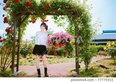 Rose gate and cute girls against the background of various roses Rose gate and cute girls against the background of various roses 77775915