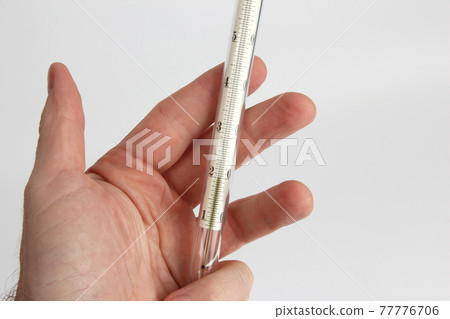 thermometer in hand closeup thermometer in hand closeup 77776706