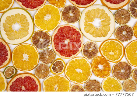 Dried slices of various citrus fruits on white background Dried slices of various citrus fruits on white background 77777507