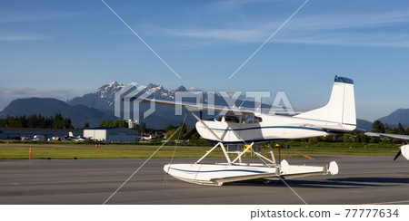 Airplanes parked at the Airport Apron during a sunny day. Airplanes parked at the Airport Apron during a sunny day. 77777634