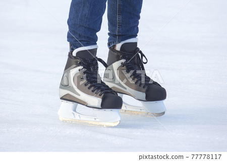 feet skating on the ice rink. Hobbies and sports. Vacations and winter activities. 77778117