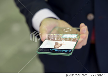 A businessman who uses a next-generation smartphone (image) 77778643