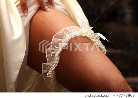 bride shows her wedding garter bride shows her wedding garter 77778962