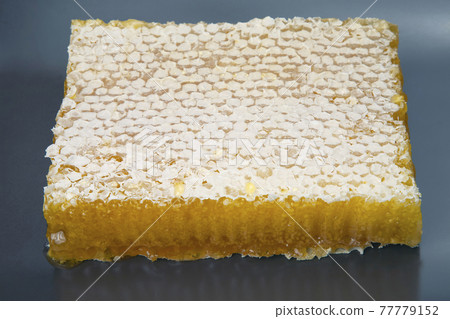 Fresh honeycomb on a gray background. vitamin and healthy natural foods 77779152