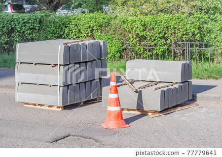Border stones on the pallet by the construction site. Border stones on the pallet by the construction site. 77779641