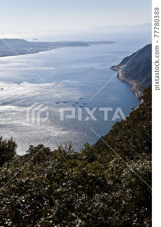A distant view of Sakurajima and the white waves of Kinko Bay A distant view of Sakurajima and the white waves of Kinko Bay 77780389