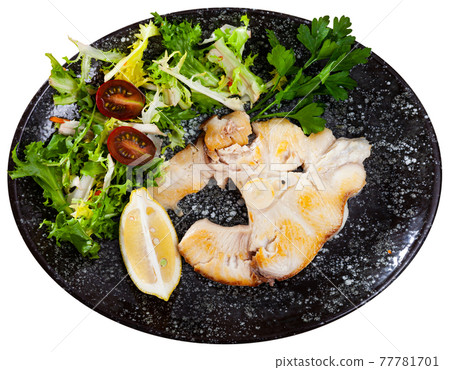 Dish of ocean fish tintorera with lemon and herbs. 77781701