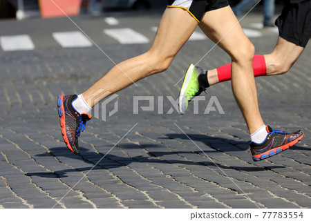 athletes run marathons on the pavement 77783554