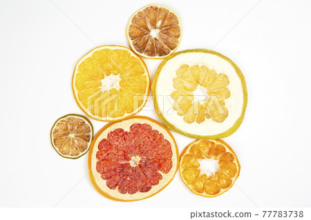 Dried slices of various citrus fruits on white background 77783738