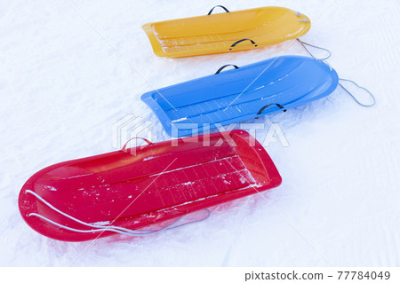 Empty colorful snow sledge on lockdown Empty colorful snow sledge on lockdown 77784049