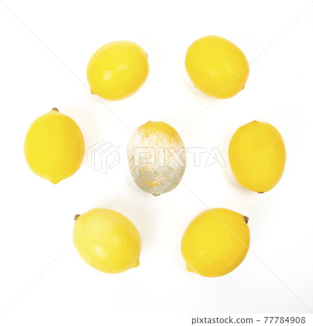 Rotten lemon next to fresh lemons on a white background 77784908
