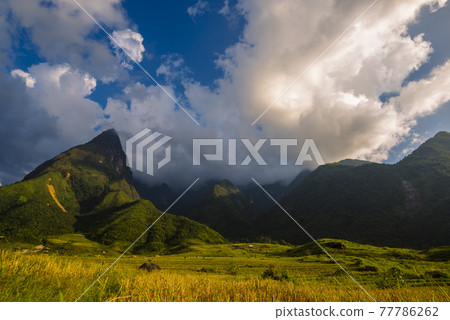 Beautiful landscape mountain green field grass meadow white cloud blue sky on sunny day. Majestic green scenery big mountain hill cloudscape valley panorama view in countryside greenery pasture 77786262