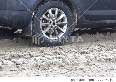 passenger car drives on a snowy road passenger car drives on a snowy road 77786910