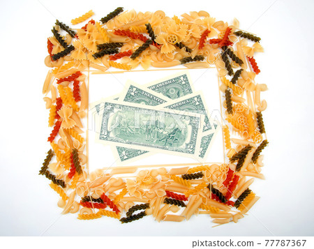 frame from italian pasta with dollars on a white background. flour products and food in cooking 77787367