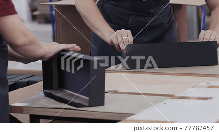 Workers laminated cardboard box. Modern factory of production cardboard box. Manufacture of cardboard boxes from paper. Enterprise for production package 77787457