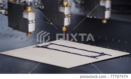 Modern automatic machine line of cardboard box. Offset printing machine - spraying glue. Conveyor line for the production Manufacture of cardboard boxes from paper. gluing of cardboard. 77787474