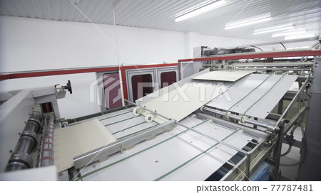 Conveyor line for the production of boxes. Machine carves and bends cardboard boxes from sheets of cardboard. Enterprise for the production package Conveyor line for the production of boxes. Machine carves and bends cardboard boxes from sheets of cardboard. Enterprise for the production package 77787481