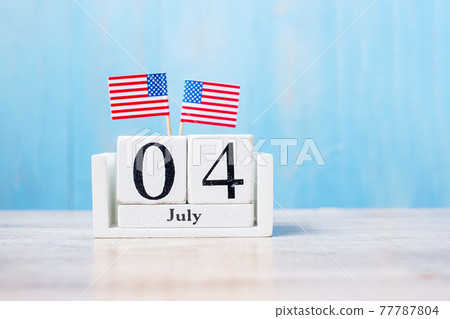Wooden calendar of July 4th with miniature United States of America flag on wood background. Independence day and nation Holiday concept Wooden calendar of July 4th with miniature United States of America flag on wood background. Independence day and nation Holiday concept 77787804