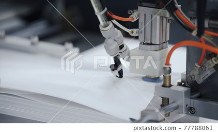 Modern automatic machine line of cardboard box. Conveyor line for the production Manufacture of cardboard boxes from paper. gluing of cardboard. Modern automatic machine line of cardboard box. Conveyor line for the production Manufacture of cardboard boxes from paper. gluing of cardboard. 77788061