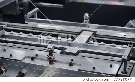 Modern automatic machine line of cardboard box. Conveyor line for the production Manufacture of cardboard boxes from paper. gluing of cardboard. Modern automatic machine line of cardboard box. Conveyor line for the production Manufacture of cardboard boxes from paper. gluing of cardboard. 77788077