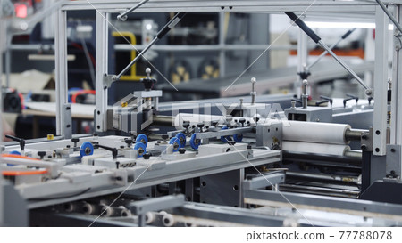 Modern automatic conveyor line for the production of package. Modern factory of production cardboard box. Manufacture of cardboard boxes from paper. Enterprise for production package Modern automatic conveyor line for the production of package. Modern factory of production cardboard box. Manufacture of cardboard boxes from paper. Enterprise for production package 77788078