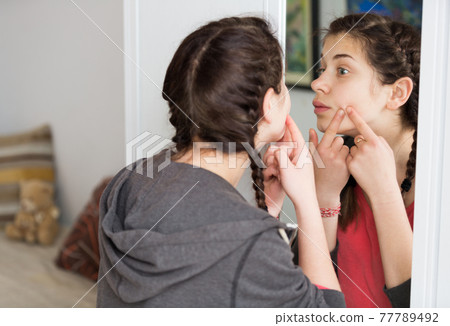 Girl cleaning pores 77789492