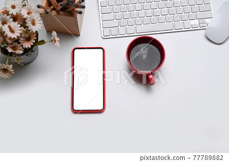 Top view modern workspace with coffee cup, headphone, notebooks and keyboard on white table. 77789882